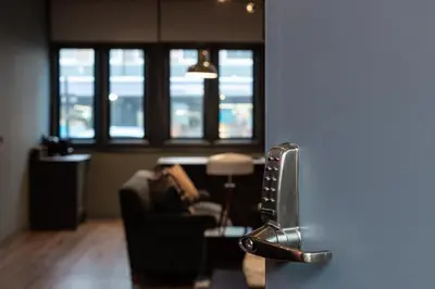 a living room with a couch and a chair and windows at Large Studio Apartment, Free Parking, Close to Centre in Southend-on-Sea