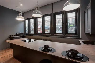 a kitchen with a large island in a room with windows at Large Studio Apartment, Free Parking, Close to Centre in Southend-on-Sea
