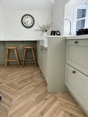 a kitchen with a counter and a clock on the wall at Historic Retreat Near To Mersea Island in Peldon