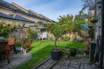 a garden with a small tree in a pot at Elegant Period House in the Historic Heart of Cambridge - sleeps 12 in Cambridge