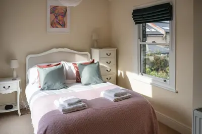 a bedroom with a bed with towels on it at Elegant Period House in the Historic Heart of Cambridge - sleeps 12 in Cambridge
