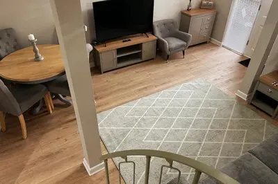 a living room with a television and a table and chairs at Horseshoe house in Sudbury