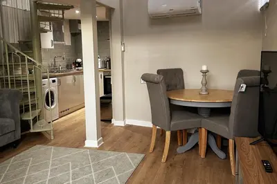 a kitchen and dining room with a table and chairs at Horseshoe house in Sudbury