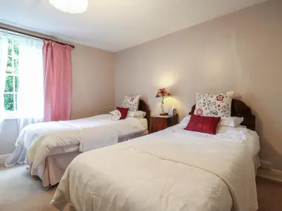 a bedroom with two beds and a window at Curry Farm in Southminster