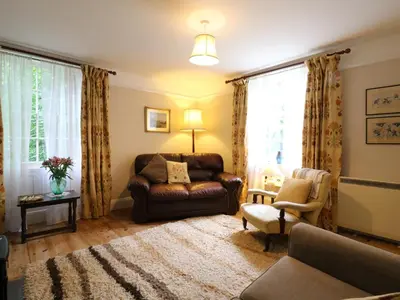 a living room with a couch and a chair at Curry Farm in Southminster