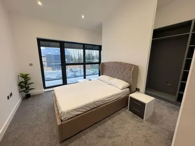 a bedroom with a bed and a large window at Amazing 3-bedroom in Great Warley, Brentwood in Great Warley Street