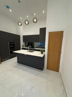 a large kitchen with a sink and a wooden door at Amazing 3-bedroom in Great Warley, Brentwood in Great Warley Street