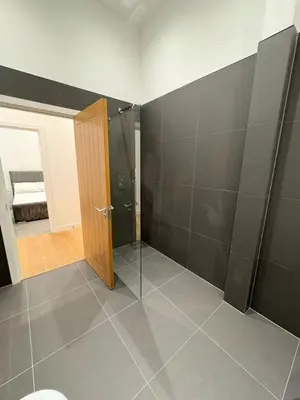 a bathroom with a shower and a door in a room at Amazing 3-bedroom in Great Warley, Brentwood in Great Warley Street