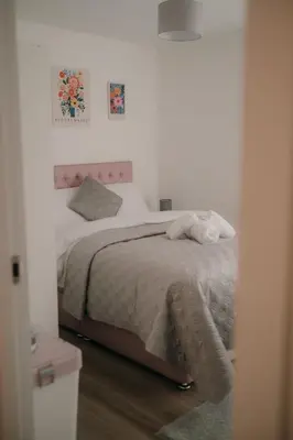 a bedroom with a bed with a pink headboard at Modern Stay - Walk to Everything 1 in Ipswich