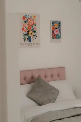 a bedroom with a bed with a flower painting on the wall at Modern Stay - Walk to Everything 1 in Ipswich