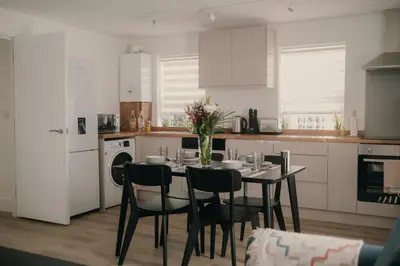 a kitchen with a table and chairs in a kitchen at Modern Stay - Walk to Everything 1 in Ipswich