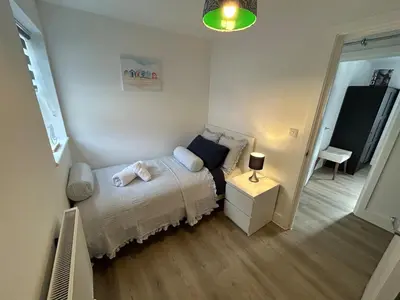 a small bedroom with a bed and a night stand at Modern Stay - Walk to Everything 4 in Ipswich