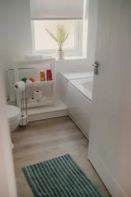 a bathroom with a tub and a toilet and a window at Modern Stay - Walk to Everything 4 in Ipswich