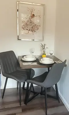 a dining room table with two chairs and a black table and chairs at Cozy Studio Newly Furnished in Colchester