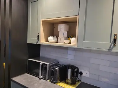 a kitchen counter with a microwave and some boxes at Cozy Studio Newly Furnished in Colchester