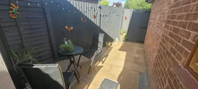 a small patio with a table and a fence at Cozy Studio Newly Furnished in Colchester