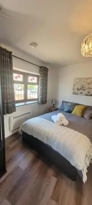 a bedroom with a large bed and a window at Cozy Studio Newly Furnished in Colchester