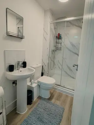 a bathroom with a toilet and a sink and a shower at Modern Stay - Walk to Everything 2 in Ipswich