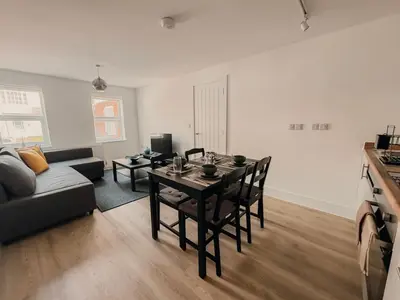 a living room with a table and a couch at Modern Stay - Walk to Everything 2 in Ipswich