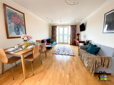a living room with a table and a couch at CB Stays - 2 Bedroom & 2 Toilet Flat - Near Mills Road and Train Station with Parking in Cambridge