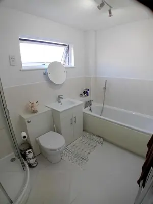 a white bathroom with a toilet and a sink at 'Ks' Yard in Great Dunmow