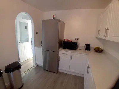 a kitchen with a stainless steel refrigerator and a window at 'Ks' Yard in Great Dunmow