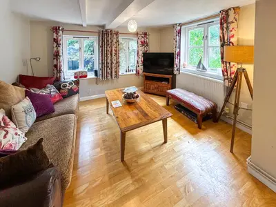 a living room with a couch and a table at Hill House in Snape