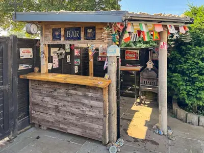 a bar with a wooden counter in front of it at Hill House in Snape