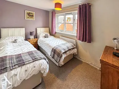 a bedroom with two beds and a window at Hill House in Snape