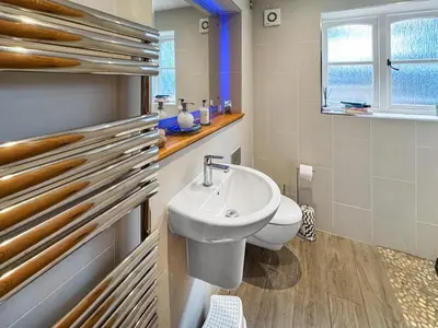 a bathroom with a white sink and a toilet at Hill House in Snape