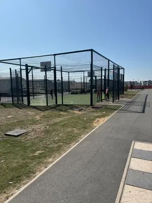 a batting cage with people in it next to a road at Singh&Leite Family RF10 in Jaywick Sands