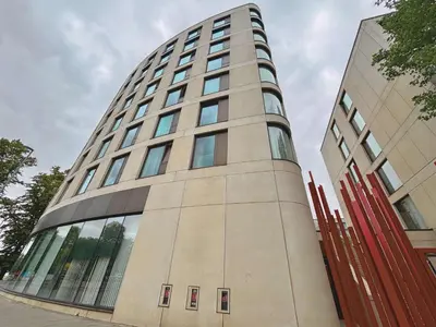 a tall building with glass windows on it at Modern Central Apartment with Parking in Cambridge