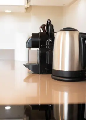 a tea kettle is sitting on a kitchen counter at Modern Central Apartment with Parking in Cambridge