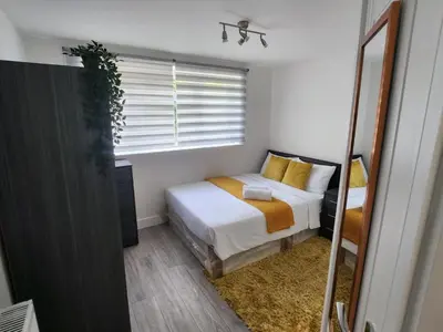 a bedroom with a bed and a window at Ensuite deluxe home in Basildon