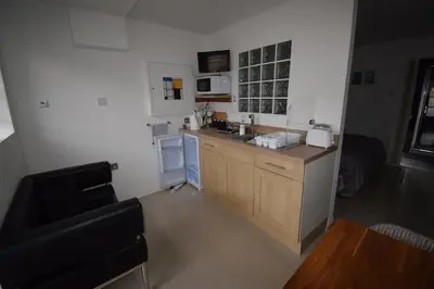 a small kitchen with a counter and a sink at Eco Deco in Frinton-on-Sea