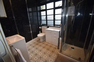 a bathroom with a toilet and a sink and a shower at Eco Deco in Frinton-on-Sea
