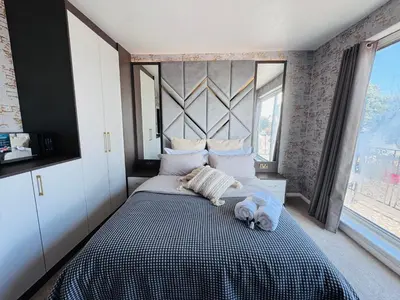 a bedroom with a bed with two towels on it at Pacific Hotel in Clacton-on-Sea