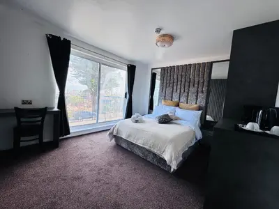 a bedroom with a bed and a large window at Pacific Hotel in Clacton-on-Sea