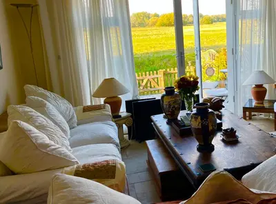a living room with a couch and a table with a view at Valley View in Sudbury