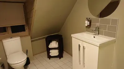 a small bathroom with a toilet and a sink at Alma Inn & Dining Rooms in Harwich