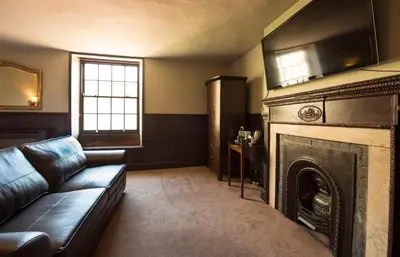 a living room with a couch and a fireplace at Alma Inn & Dining Rooms in Harwich