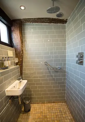 a bathroom with a sink and a blue tile wall at Alma Inn & Dining Rooms in Harwich