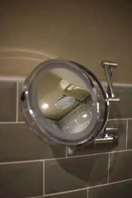 a mirror hanging on the wall of a bathroom at Alma Inn & Dining Rooms in Harwich