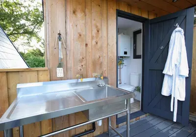 a large stainless steel sink in a bathroom at Sycamore Lodge with Hot Tub- Quirky & Romantic in Halstead