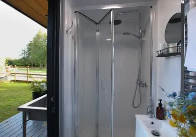 a bathroom with a shower and a sink at Sycamore Lodge with Hot Tub- Quirky & Romantic in Halstead