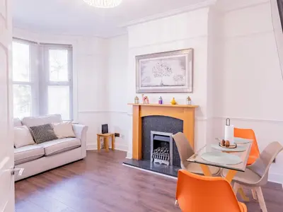 a living room with a couch and a fireplace at Pass the Keys Comfortable Flat with Patio Sleeps 4 in Westcliff On Sea