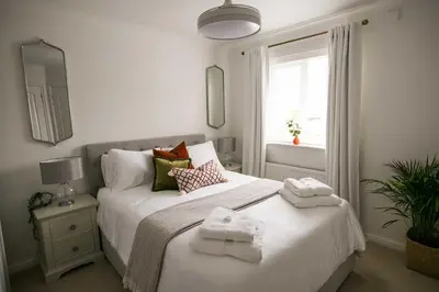 a bedroom with two beds with towels on them at Your home away from home in Bury Saint Edmunds