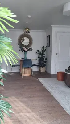 a living room with a table and a mirror at Your home away from home in Bury Saint Edmunds