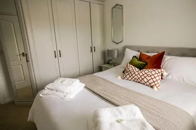 a bedroom with two white towels on a bed at Your home away from home in Bury Saint Edmunds