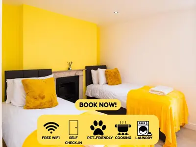 a room with two beds and a sign that says book now at Cozy 2BR 2BATH Apt in Central Ipswich - Sleeps 6 & Prime Location in Ipswich